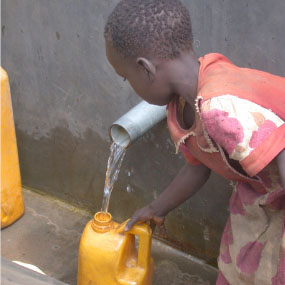 boy filling water jug