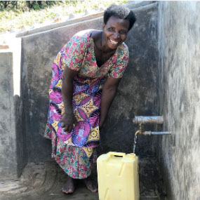 woman getting water from well