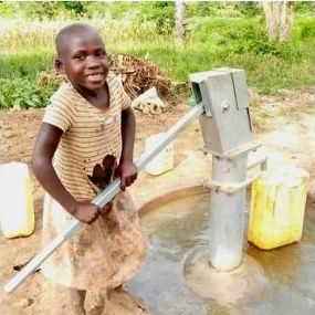 boy pumping water from well
